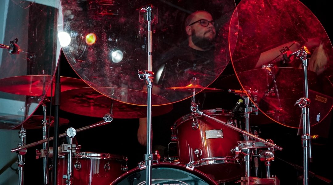Keith behind the drum kit bathed in red light